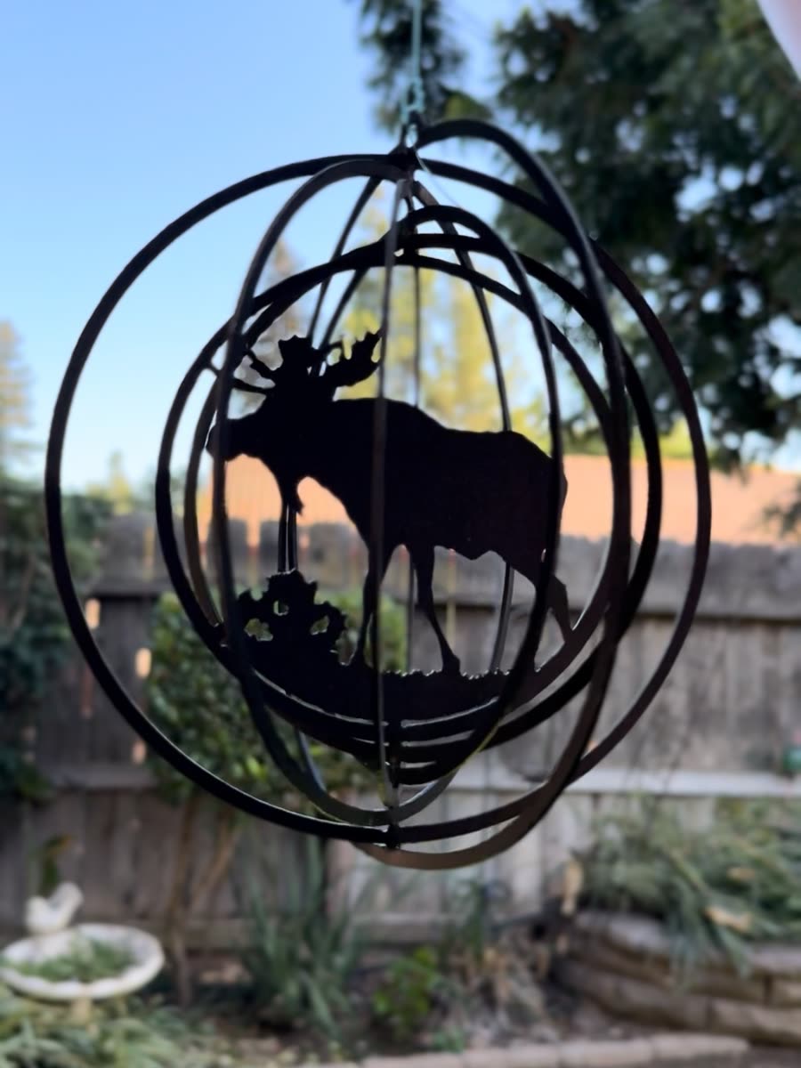 Moose silhouette inside a round steel frame.