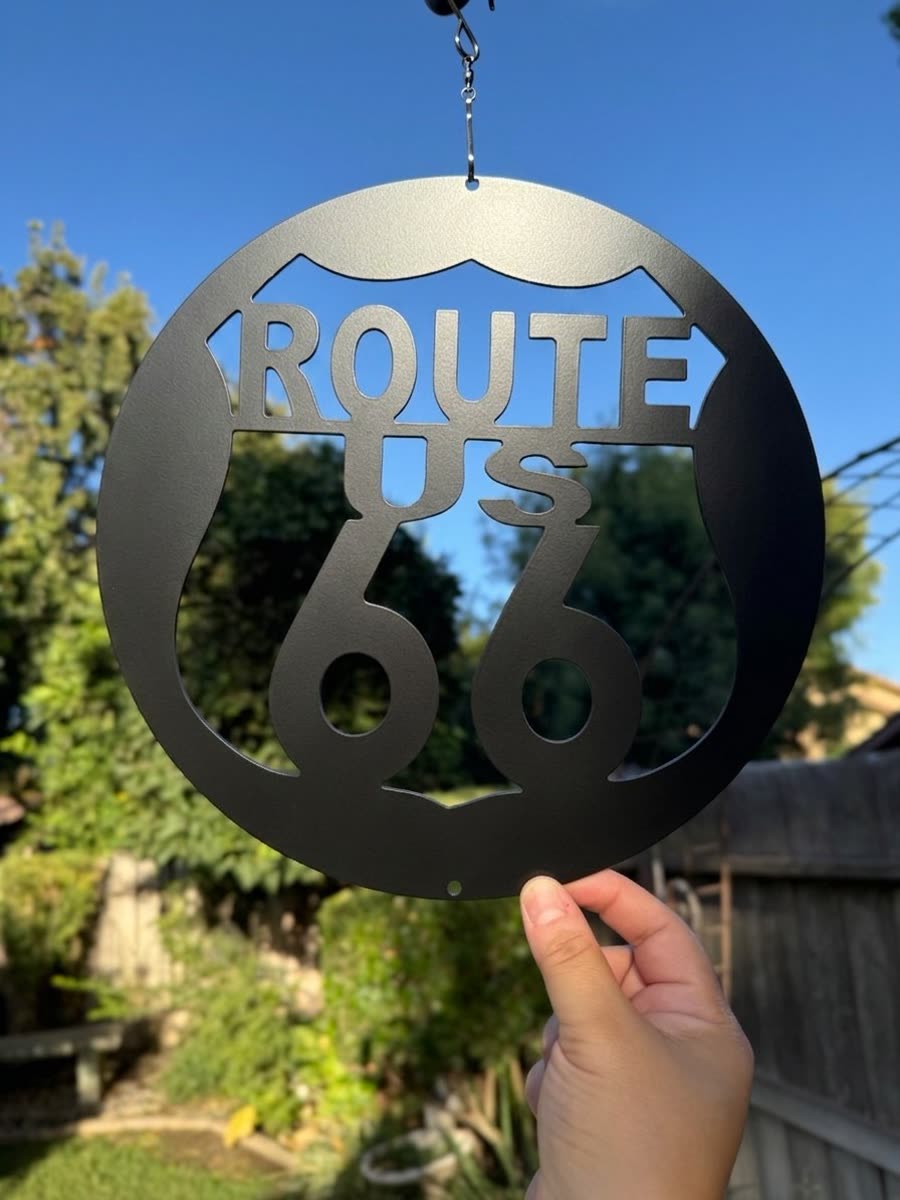 Route US 66 shield cut inside a hanging steel ring.